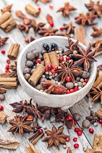 A healthy array of star anise pods, berries, and cinnamon sticks